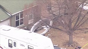 Mid-air explosion causes large parts of plane to rain down on neighbourhood