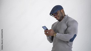 Black man in glasses texting on the phone. Portrait of a handsome afro american man using mobile phone typing sms message. Copy space.