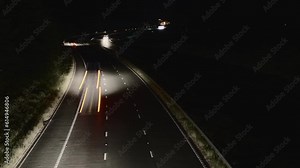 Dark British M6 motorway with vehicle light trails, long exposure time lapse, Tebay, Cumbria, UK