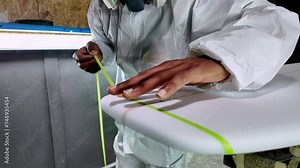 Surfboard manufacturing, Shaper working on board details. Concept of industrial manufacturing, qualified professional, occupation and employment.