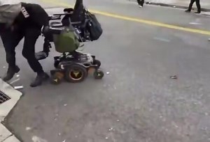 Wheelchair bound ICE protestor has Devine intervention and rises from his chair to pick up his cellphone that he dropped. | James Johnson