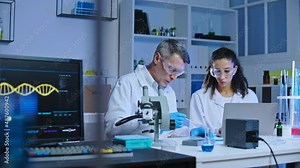 DNA laboratory scientists conducting experiment with blood samples, research