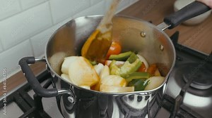 Cooking Video. Close up of food cooking simmering in a pan full of curry sauce, soup or stew placing ingredients herbs spices pan ready for cooking. Happy household chores healthy eating concept. Stock Video