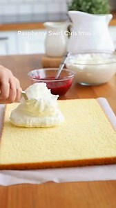 Raspberry Swirl Christmas Roll Snowy Noël Vanilla Roll with Ruby Raspberry Swirl Recipe Ingredients: 1 box vanilla or white cake mix (plus ingredients listed on the box) ¾ cup raspberry preserves 1 tub (8 oz) Cool Whip, thawed Powdered sugar, for dusting Directions: Preheat the oven according to the cake mix instructions. Line a 10×15-inch jelly roll pan with parchment paper and lightly grease it. Prepare the cake batter as directed on the box and spread it evenly into the prepared pan. Bake acc