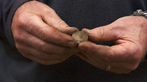 During a meticulous investigation at Samuel Ball’s property, Alex Lagina discovers a stunning artifact later confirmed to be a British Navy Jacket Button. | The Curse of Oak Island
