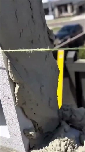 Applying cement mortar on wall using leveling string guide