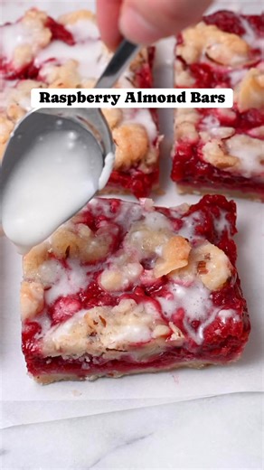 These lemon raspberry crumb bars are made with fresh or frozen raspberries. They have a buttery shortbread crust, an almond crumble topping, and a jammy raspberry filling! | Cozy Peach Kitchen - Cassidy Reeser, RDN