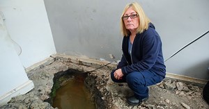 nWoman who is living with ,water filled hole in living room,n