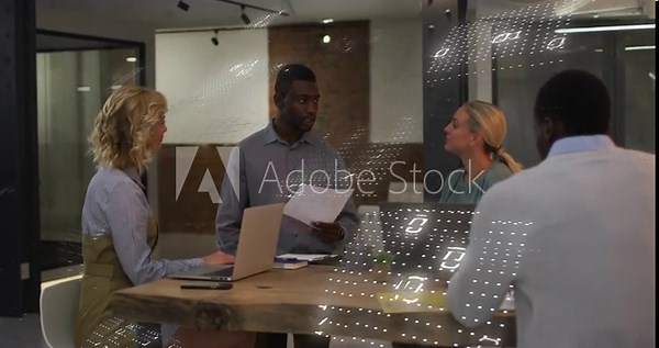Central man reading papers and initiating binary overlay, team using laptops for business review