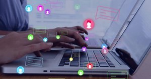 Animation of social media icons with speech bubbles over diverse colleagues using laptops. Global social media, computing, communication and digital interface concept digitally generated video.