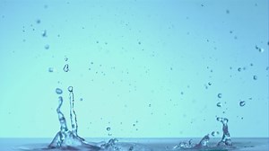 Super slow motion splashes water on a blue background. Filmed on a high-speed camera at 1000 fps.High quality FullHD footage