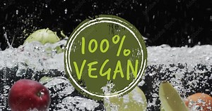 Animation of 100 percent vegan text over fruit falling in water background