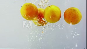 Orange and water splash. Integration of oranges with water. Artistic footage of oranges falling into water in slow motion.