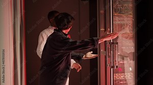 Lockdown of male African IT specialist and his Asian coworker running into server room where alarm triggered