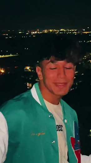 Exploring the Night Cityscape in a Stylish Varsity Jacket