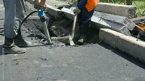 Road Paving. Workers laying stone mastic asphalt during street repairing works. Worker making asphalt with coated chippings. Drainage repair, installation of manhole Stock Video