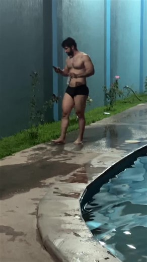 Muscular Man Jumps into Pool with Smartphone and Can