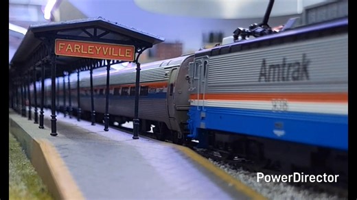 An evening Metroliner calls at Farleyville behind an AEM-7. | Suncoast Model Railroad Club