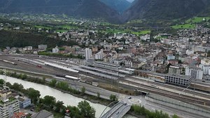 The train station of Brig in the canton of Valais in Switzerland. Behind the station is the city of Brig and further up the mountain is the pass road to the Simplon Pass
