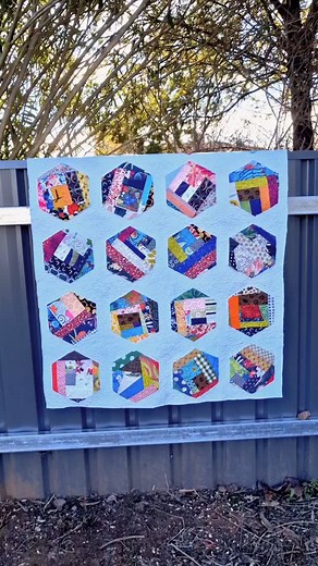 Scrappy blocks cut into big hexagons, Raw edge appliqued onto white cotton squares. 20 blocks. The hexagons are quilted with a meandering stitch and hopefully the edges will fuzz up over a few washes. Zentangle quilting for the white background. Broke all the quilt police rules, but hey, my quilt, my way. I think I am now a card carrying member of the idgaf club! 🤣 Bindings next. I will decide on that tomorrow. #pamelacohenstudioart #quiltart #hexagonscraps #appliquehexagons #rawedgeapplique #d