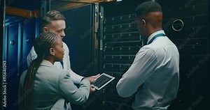 Team in server room with tablet, discussion for engineering and network maintenance for data update. Tech support, men and woman in system administration with digital app for technician in datacenter