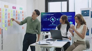 brainstorming session, using sticky notes on a task board (kanban) to organize ideas and workflow in a modern office