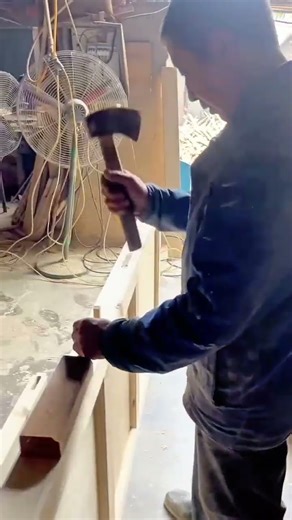 Carpenter Hammering Wood in the Workshop