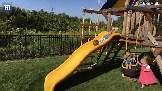 Little boy faceplants into grass going down slide head first | Daily Mail Online
