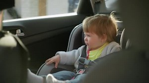 Baby doesnt like being in a car seat. Little girl crying in the car