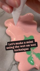 4.9K views · 322 reactions | The wet on wet technique can make some fun designs using royal icing. For this mint, I piped the white and red icing into a wet background icing and then use my scribe to move the icing around, creating a working mint effect. #wetonwetcookies #royalicing #royalicingcookies #shortbreadcookies #satisfyingvideos #cookiedecoratingvideo #cookiereels | Kristel's Cookie Creations | Facebook