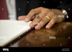 22 January 2009 - Washington, DC - U.S. President Barack Obama holds a pen prior to signing the first of four executive orders to close the Guantanamo Bay Detention facility, on his desk in the Oval Office at the White House in Washington, DC, USA on 22 January 2009. Vice President Joseph Biden and a group of retired military officers attended the ceremony. Photo Credit: Matthew Cavanaugh/Pool/Sipa Press/0901221930 Stock Photo - Alamy