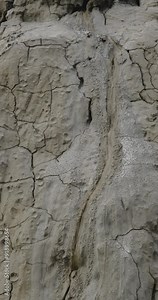 Muddy Vulcanos located in Buzau County, Romania, a National Landmark, Gas bubbles coming out a mud volcano. Paclele mici and Paclele Mari