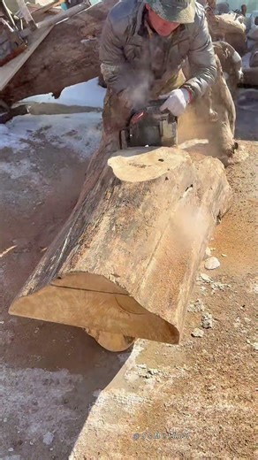 Skilled Chainsaw Carving to Shape a Large Natural Log Section