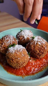 Get 🔥 with @dope__kitchen and make some Arancini! Leftover risotto, cold Panko breadcrumbs Garlic powder Italian seasoning Salt & pepper Flour 1 egg Cheese (mozzarella or goat cheese) Vegetable or canola oil for frying In three separate bowls, add flour to one, beaten egg in another, and Panko breadcrumbs in the last. Season everything with salt and pepper. Add garlic powder and Italian seasoning to the flour and Panko. Use an ice cream scoop to scoop the risotto. Flatten it, then add a cube of