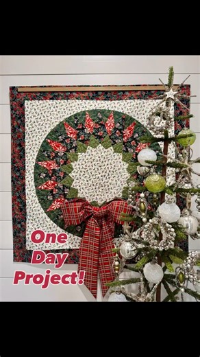 Robin Ruth Design on Instagram: "Decided to do a little Sunday sewing and put this together yesterday! Started by pulling fabric from my stash about 8am and finished binding this before 4! This is a 30” Fat Robin 32-Point Compass Sunflower Version 2 block using my reverse appliqué technique for finishing the center. This block was appliquéd onto a 35.5” background square and then I added 3.5” borders. The bow was made by sewing two 10” strips end to end, folding them in half with right sides tog