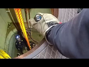 Video: First responders drop into manhole cover to rescue worker