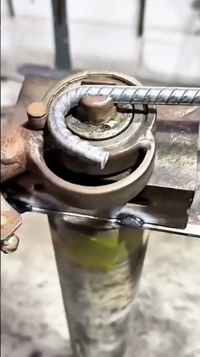 Bending a steel rebar using a manual bending tool, shaping it precisely for construction use