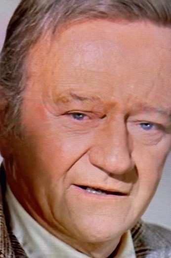 JOHN WAYNE DRINKING COFFEE IN “BRANNIGAN.”
