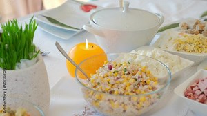 Traditional Polish Easter Celebration Table Setting With Salad Dish Cottage Chopped Cheese Ham Eggs and Wax Candle