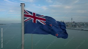 New Zealand flag blowing in the wind over Auckland city, New Zealand