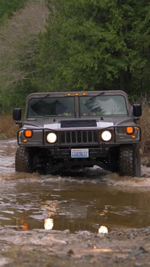 Hummer H1 driving through icy water