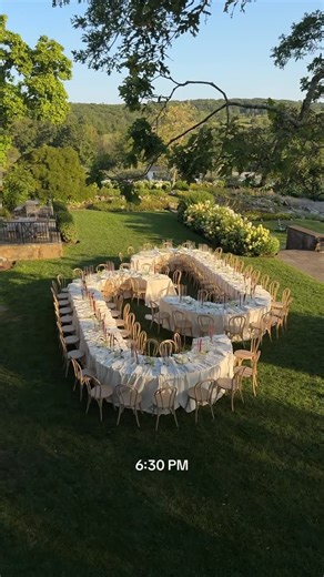Monica Relyea on Instagram: "The curved tables mirrored the couple’s logo, their interplay creating the feeling of one long, communal table. Paired with the lusciousness of the gathered linens, the goal was always connection. Dining alfresco in August, guests experienced an intimate evening lit mostly by candlelight. Minimal florals, thoughtful table settings, and the glow of the Perkins House stone façade made this backyard terraced celebration feel both elevated and deeply personal. #hudsonval