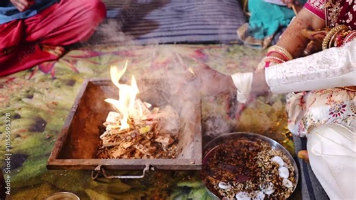 Authentic Indian marriage vidhi video showing traditional Hindu wedding rituals and sacred ceremonies. Features bride and groom performing wedding customs, Vedic rituals, priests, sacred fire (havan),