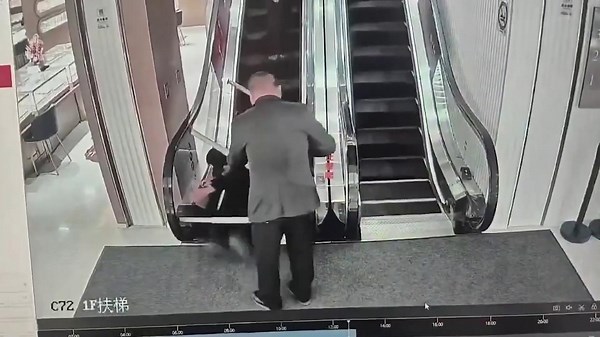 Slapstick-esque security guards carrying tables get tangled in escalator