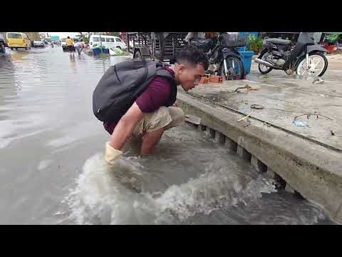 Clean Up Plastic Dirty Clogged culvert Drain After Heavy Rain Flooding on the Street