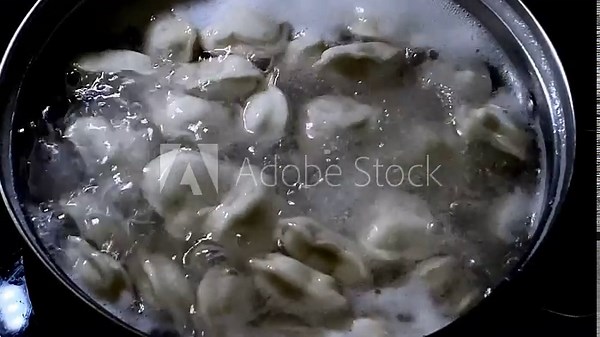 Boiling dumplings scene. Vivid image of dumplings boiling with foam