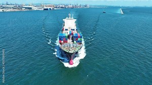 Aerial front view of cargo ship carrying container and running for export goods from cargo yard port to custom ocean concept technology transportation , customs clearance. forwarder