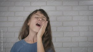 Child crying because of toothache. Little girl with toothache.