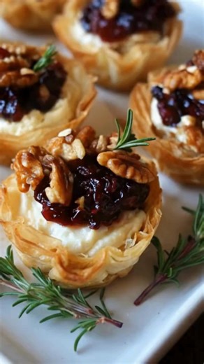 Phyllo cups filled with creamy Brie, toasted pecans, and sweet cranberry drizzle. Bake at 350°F for 10 minutes until the cheese melts and bubbles. Each bite is buttery, tangy, and perfectly festive an elegant appetizer in minutes. Ingredients: ➤ 12 mini phyllo cups ➤ 120 g (½ cup) Brie cheese, cut into small pieces FULLL Recipe in First Cօʍʍеոτ 👇👇👇 | Nessy Recipes