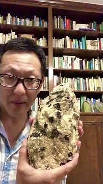 What is a pegmatite and how do large crystals form?
